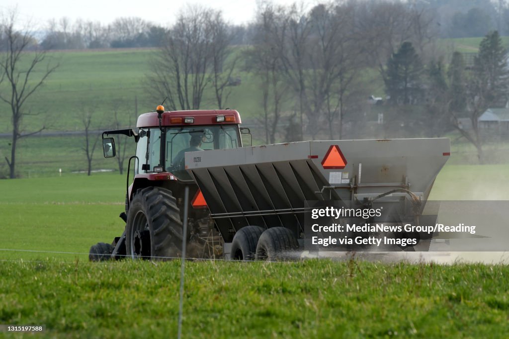 A farmer spreads fertilizer on his field on a Saturday night beside Covered Bridge Road near Spangsville, Oley Township on Saturday, April 14, 2018. Photo by Harold Hoch BC Last Look RNP Images