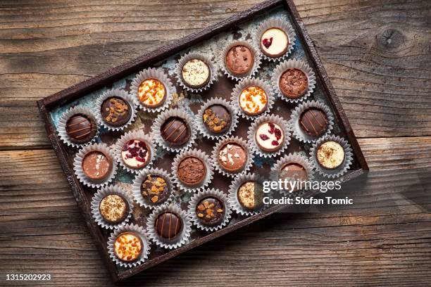 luxurious chocolate praline candies set with nuts and dried fruits - box of chocolates stock pictures, royalty-free photos & images