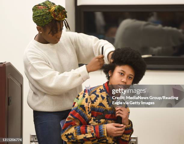 Kayla Frison, the Black Student Union President, demonstrates how to do a corn row braid on Whitney Allen, 21. At Penn State Berks for "Being Black...