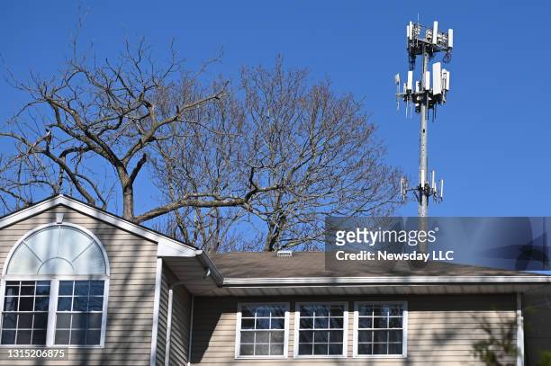 Cell tower seen from behind a house on Boxer Court, in Huntington, New York, on March 30, 2021.