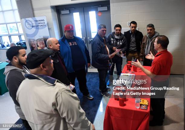 Robert Venditti of J.P. Mascaro & Sons, right, talks to a group of job seekers. Berks Career & Technology Center west campus holds a job fair and...