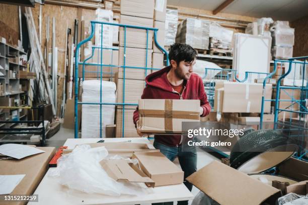 Man Intensely Sorting Young Man In Warehouse Photos and Premium High Res Pictures - Getty Images