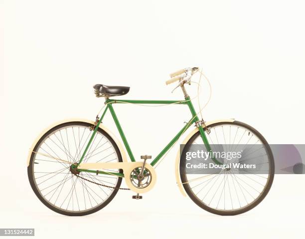 green vintage bike against white background. - fahrrad stock-fotos und bilder