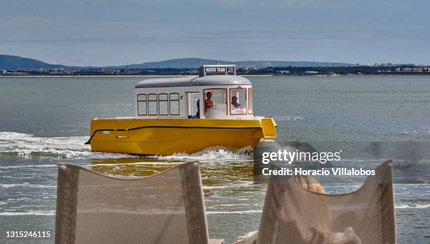 Water Tram 28, a tourist boat, sails on the Tagus River by the Quiosque Ribeira das Naus a day before the end of the state of emergency during the...