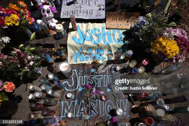 Candles, flowers and photographs are displayed at a memorial for Mario Gonzalez who died after being pinned by Alameda police officers on April 29,...