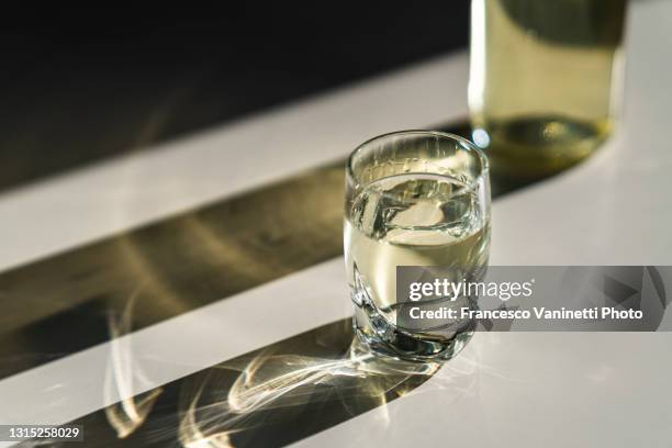 glass and bottle with hard liquor. - wodka stock pictures, royalty-free photos & images
