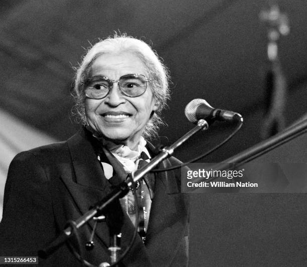 American activist in the civil rights movement best known for her pivotal role in the Montgomery bus boycott Rosa Parks smiles on stage before...