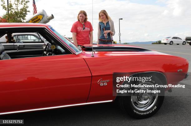 Photo Ryan McFadden Woman's Club of Birdsboro car show at Daniel Boone High School; from left is Erik Wagner of Birdsboro 22 and girlfriend Ellie...