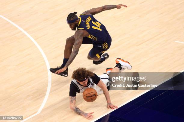 Tyler Johnson of the Brooklyn Nets and JaKarr Sampson of the Indiana Pacers dive for the ball during the third quarter at Bankers Life Fieldhouse on...