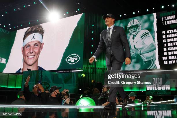 Zach Wilson walks onstage after being drafted second by the New York Jets during round one of the 2021 NFL Draft at the Great Lakes Science Center on...