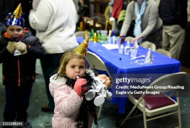 Amelia Piccione of Douglass Township, Montgomery County, practices blowing the horn she decorated before heading out to watch the bear drop during a...