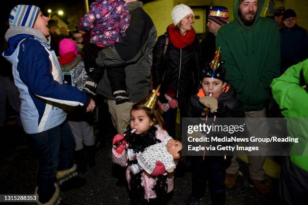 Amelia Piccione and her brother, Joe Piccione of Douglass Township, Montgomery County, ring in the New Year during a New Year's celebration Sunday at...