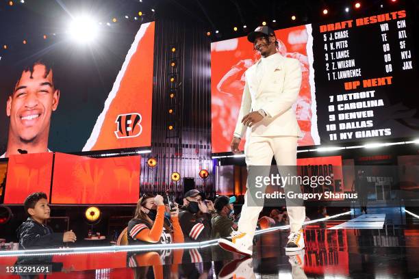 Ja'Marr Chase walks onstage after being selected fifth by the Cincinnati Bengals during round one of the 2021 NFL Draft at the Great Lakes Science...