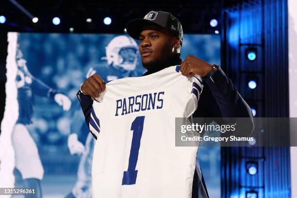 Micah Parsons poses onstage after being selected 12th by the Dallas Cowboys during round one of the 2021 NFL Draft at the Great Lakes Science Center...