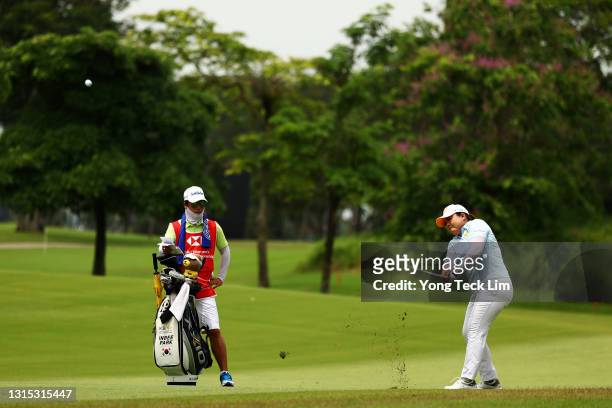 Inbee Park of South Korea plays her second shot from the 10th fairway as her husband and caddie Gi Hyeob Nam looks on during the second round of the...