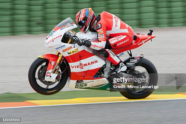 Stefan Bradl of Germany and Viessmann Kiefer Racing lifts the front wheel during the qualifying practice of the MotoGP of Valencia at Ricardo Tormo...