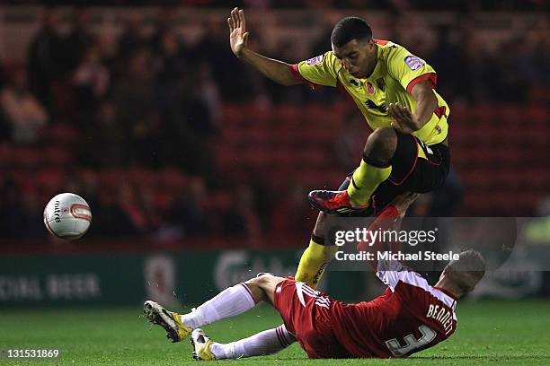 Joe Bennett of Middlesbrough feels the challenge from Troy Deeney of Watford during the npower Championship match between Middlesbrough and Watford...