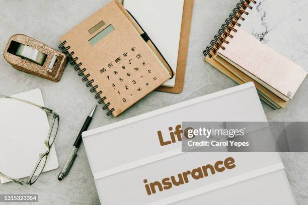 life insurance concept in offioce workplace - lebensversicherung stock-fotos und bilder