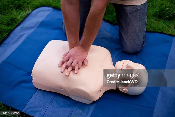 chest compressions performed on cpr dummy - cpr stock pictures, royalty-free photos & images