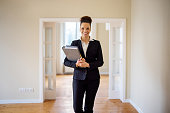 Portrait of smiling saleswoman with file at home