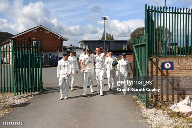 Luke Fletcher of Nottingham celebrates with Stuart Broad and teammates as he returns to the dressing rooms via the club park after taking a five...