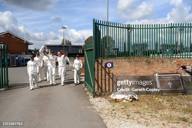Luke Fletcher of Nottingham celebrates with Stuart Broad and teammates as he returns to the dressing rooms via the club park after taking a five...