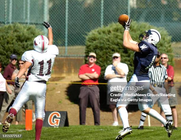 Photo by Krissy Krummenacker 200702049 Wyomissing's Marcus Line catches a touchdown pass as Central Catholic's Joseph DiCerchio looks on during the...