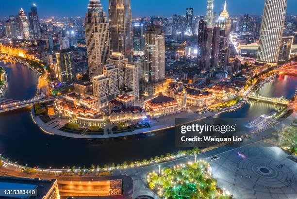 night view of the city of tianjin, china, with the river passing through the city, shot from a high angle - 天津 ストックフォトと画像