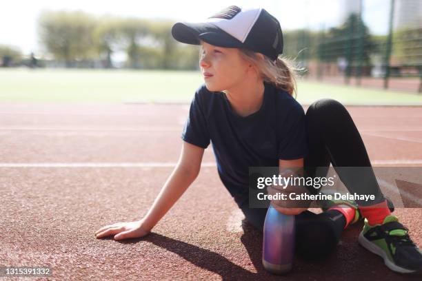 portrait of a young girl on an athletics track - water canteen stock pictures, royalty-free photos & images