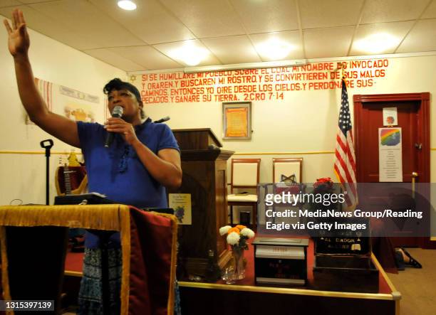 Selenia Sanchez leads the singing at a service Thursday night in the Iglesia Casa de Oracion Monte Sinai at 153 W. Buttonwood St. Photo by Bill...