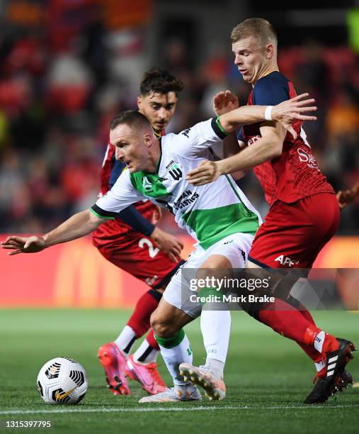 Besart Berisha of Western United competes with Jordan Elsey of Adelaide United during the A-League match between Adelaide United and Western United...