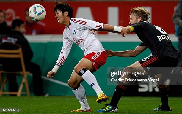 Simon Rolfes of Leverkusen and Heung-Min Son of Hamburg battle for the ball during the Bundesliga match between Bayer 04 Leverkusen and Hamburger SV...