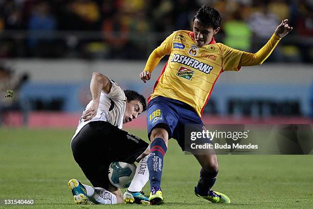 Carlos Guzman of Monarcas Morelia struggles for the ball with Jorge Rodriguez of Jaguares during a match between Morelia and Jaguares as part of...