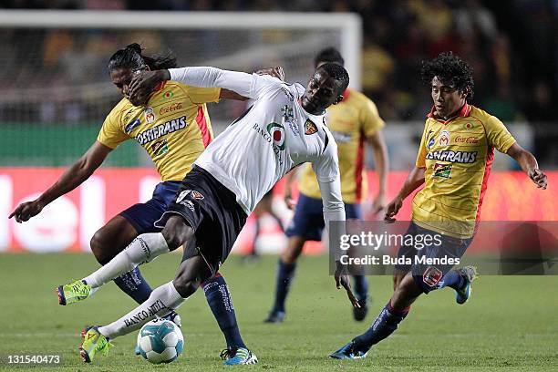 Joel Huigui and Jorge Gastelum of Monarcas Morelia struggles for the ball with Jackson Martinez of Jaguares during a match between Morelia and...