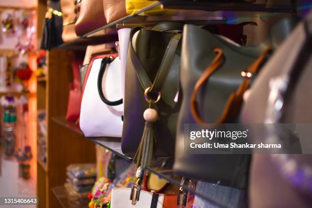 brand new designer handbags on shelves of a fashion store, out for sale. - designer bag stock pictures, royalty-free photos & images