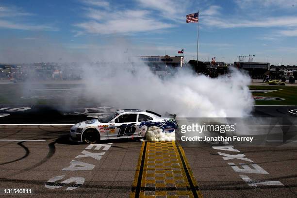 Trevor Bayne, driver of the RickyVsTrevor.com Ford, celebrates with a burnout after winning the NASCAR Nationwide Series O'Reilly Auto Parts...
