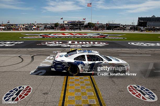 Trevor Bayne, driver of the RickyVsTrevor.com Ford, crosses the finish line to win the NASCAR Nationwide Series O'Reilly Auto Parts Challenge at...