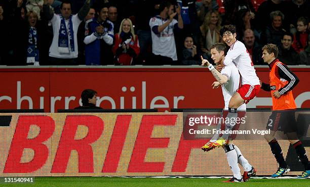 Marcell Jansen of Hamburg celebrates scoring the second goal with Heung-Min Son during the Bundesliga match between Bayer 04 Leverkusen and Hamburger...