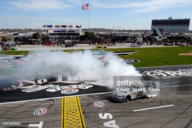 Trevor Bayne, driver of the RickyVsTrevor.com Ford, performs a burnout in celebration of winning the NASCAR Nationwide Series O'Reilly Auto Parts...