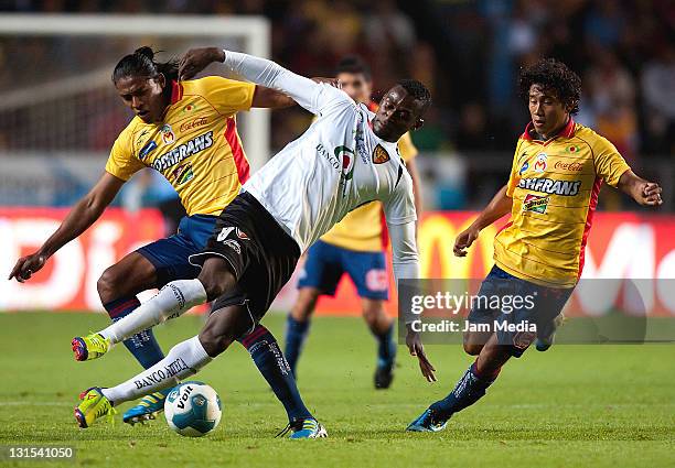 Joel Huiqui of Morelia struggles for the ball with Jackson Martinez of Jaguares during a match between Morelia and Jaguares as part of the Apertura...