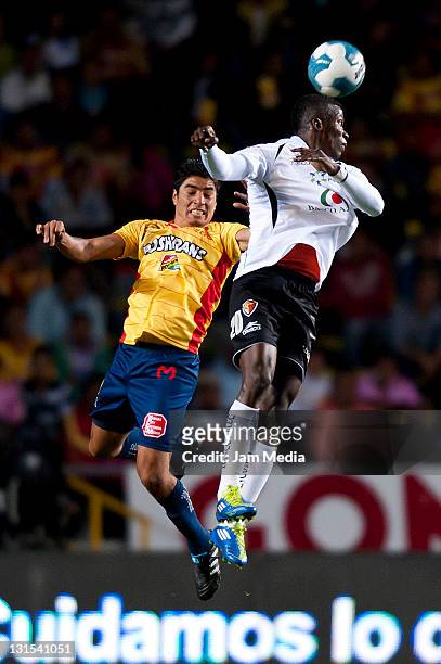 Enrique Perez of Morelia struggles for the ball with Franco Arizala of Jaguares during a match between Morelia and Jaguares as part of the Apertura...