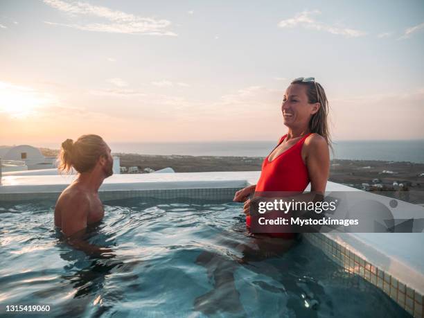 romantic couple enjoy sunset from a hot tub - bathing in sunset stock pictures, royalty-free photos & images