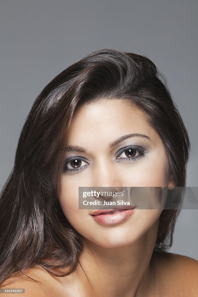Hispanic woman with long hair, smiling, portrait