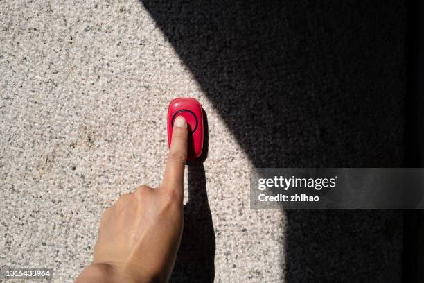 human hand is ringing the doorbell, light effect - doorbell stock pictures, royalty-free photos & images