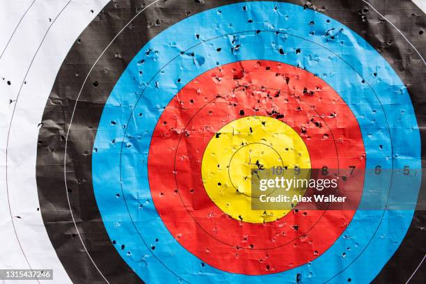 multi-coloured archery target rings with holes - cible militaire photos et images de collection