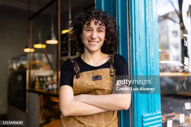 happy non-binary small business owner portrait - waiter stock-fotos und bilder