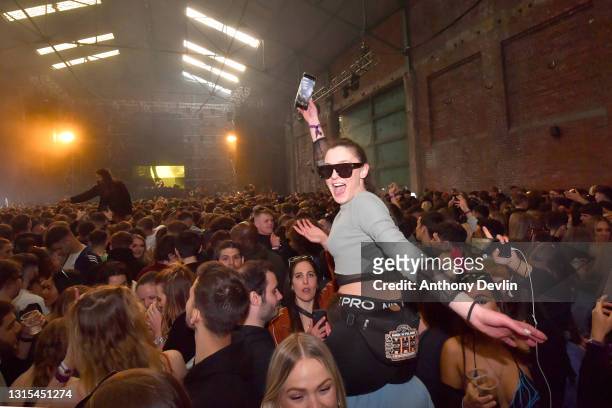 Woman reacts to the camera as Nightclub Circus hosts the first dance event, which will welcome 6,000 clubbers to the city's Bramley-Moore Dock...