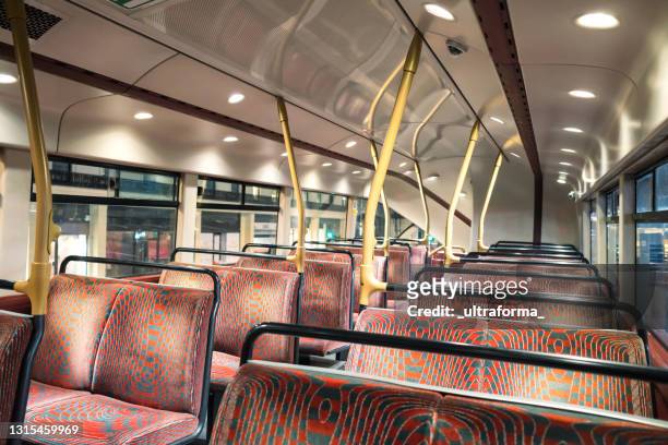 inside an empty double-decker night bus during covid-19 lockdown in london - empty seat stock pictures, royalty-free photos & images