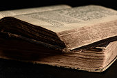 Jewish Bible. Old worn Jewish books. Opened scripture pages. Selective focus. Closeup.