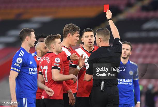 Jannik Vestergaard of Southampton is shown a red card by referee Robert Jones during the Premier League match between Southampton and Leicester City...